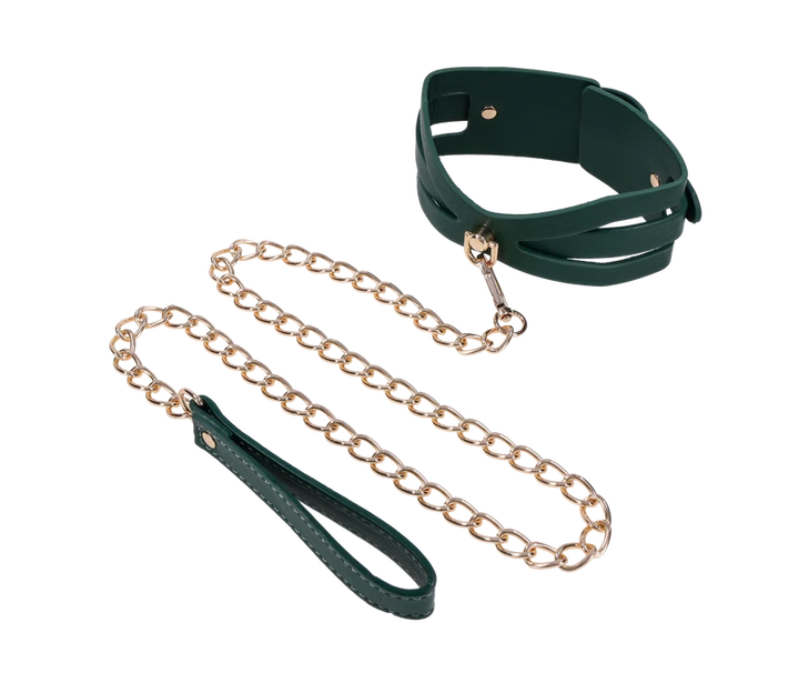 Emerald green faux leather collar with cutout detailing and a gold chain leash