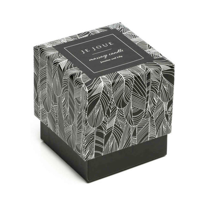 Je Joue massage candle in a glass vessel with its patterned gift box