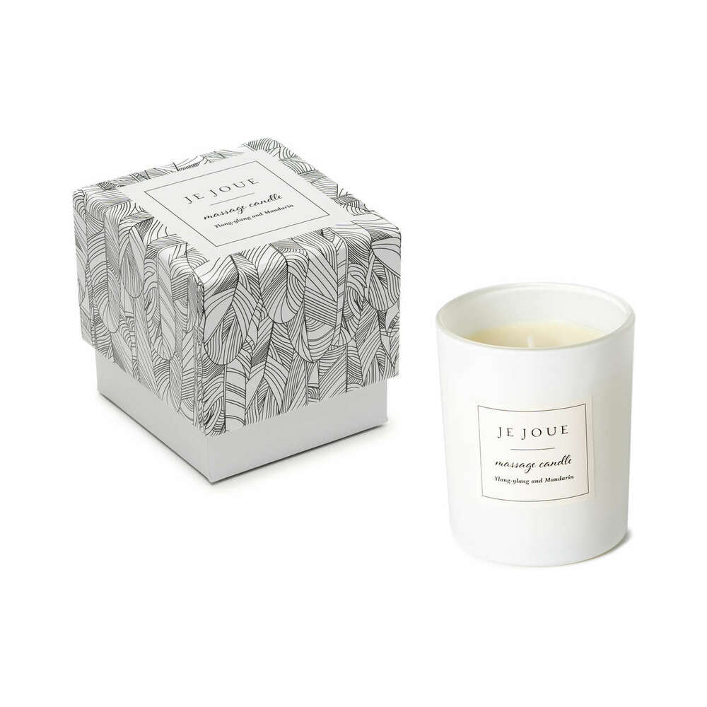 Je Joue massage candle in a glass vessel with its patterned gift box