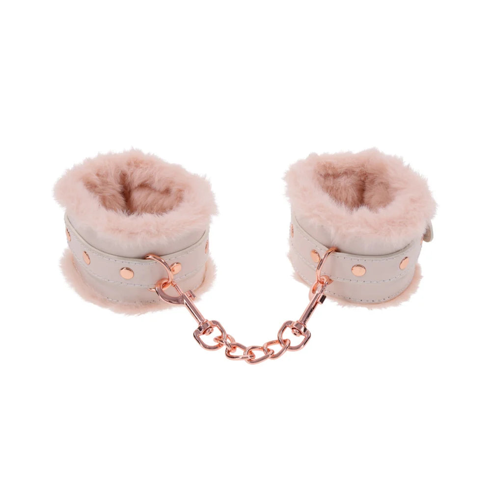 Pale peach faux leather handcuffs lined in soft faux fur, joined by a rose gold chain