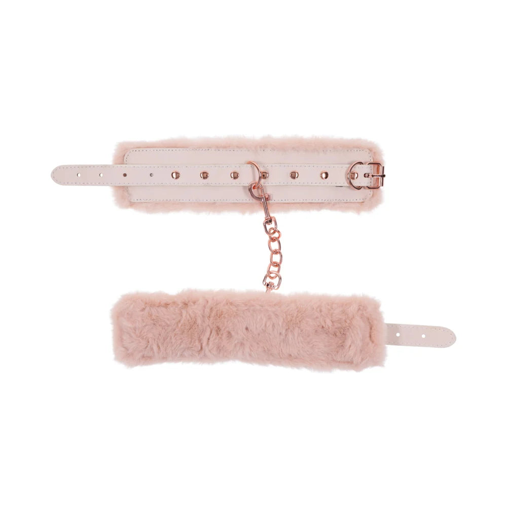 Pale peach faux leather handcuffs lined in soft faux fur, joined by a rose gold chain