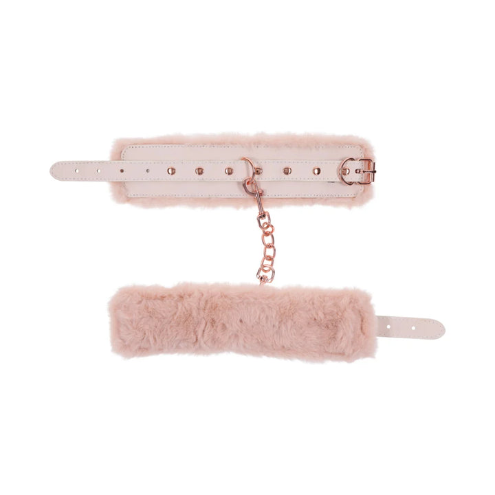 Pale peach faux leather handcuffs lined in soft faux fur, joined by a rose gold chain