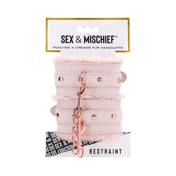 Pale peach faux leather handcuffs lined in soft faux fur, joined by a rose gold chain