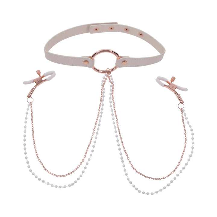 Pale peach faux leather collar with rose gold hardware and pearl chains running to two nipple clamps