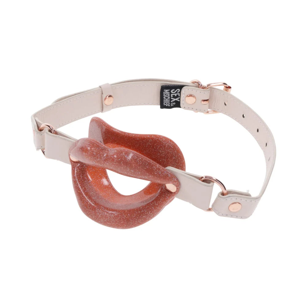 Open-mouth lip-shaped gag in pearlescent peach silicone on a faux leather strap with rose gold buckle