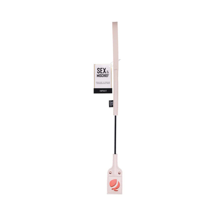 Pale peach riding crop with a looped faux leather tip cut out in the shape of a peach