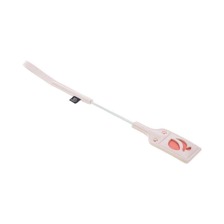 Pale peach riding crop with a looped faux leather tip cut out in the shape of a peach