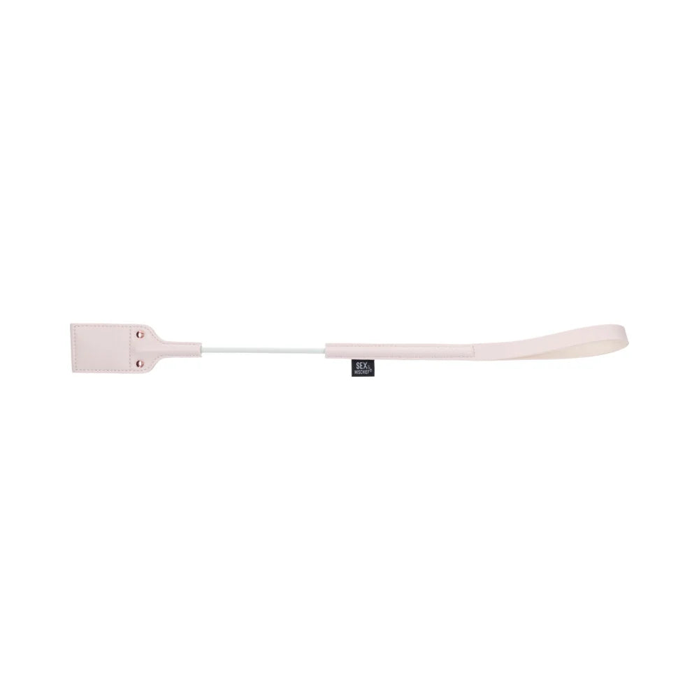 Pale peach riding crop with a looped faux leather tip cut out in the shape of a peach