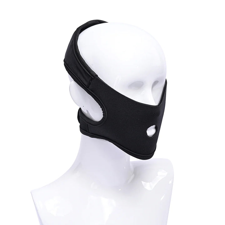 Black neoprene head harness with hook and loop straps, worn over the mouth for face-sitting play