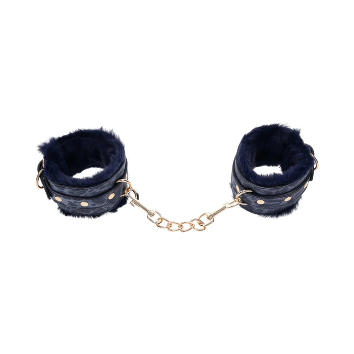 Blue animal print faux leather handcuffs lined in blue faux fur with gold hardware and chain
