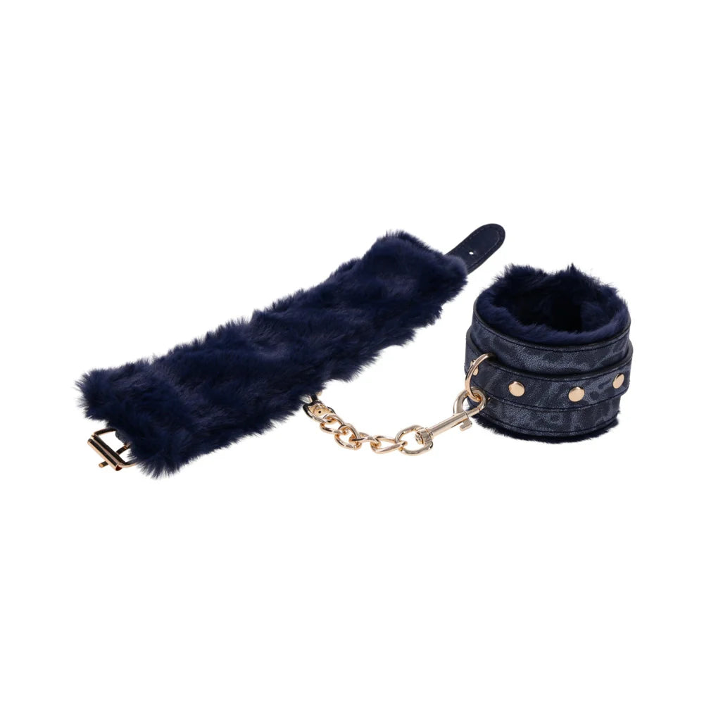 Blue animal print faux leather handcuffs lined in blue faux fur with gold hardware and chain