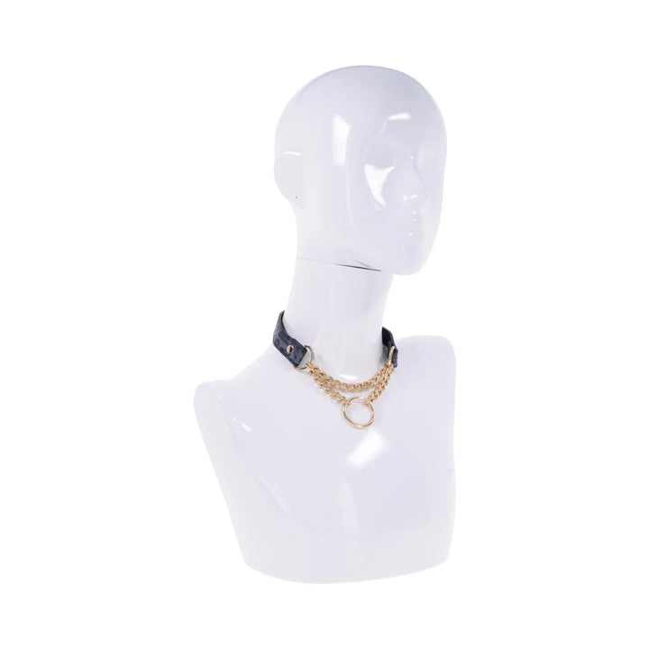 Blue animal print faux leather day collar with a draped gold chain and a gold ring at the center