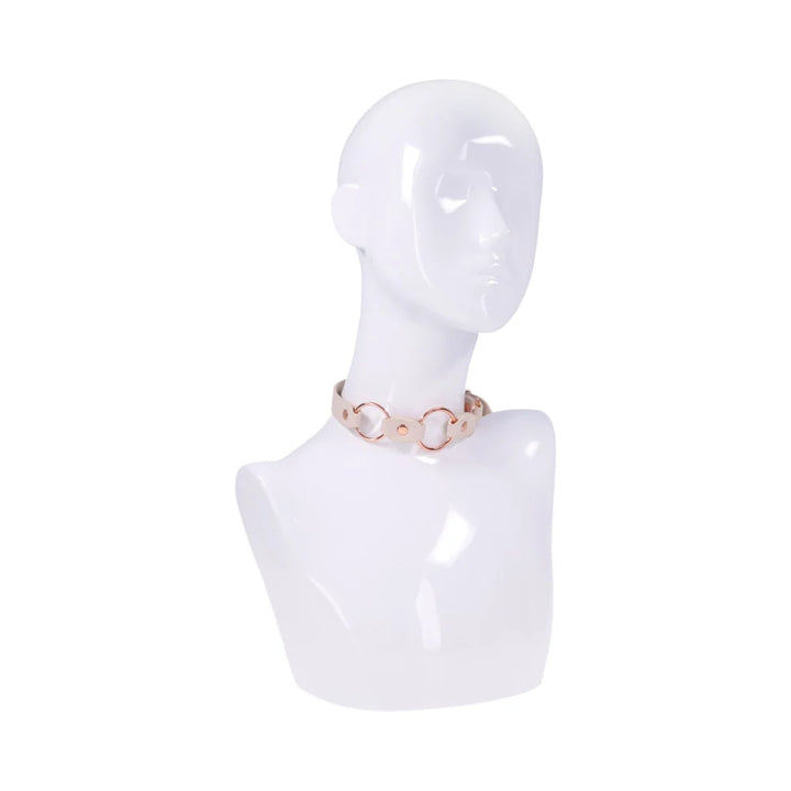 Smooth peach faux leather day collar with three rose gold rings across the front