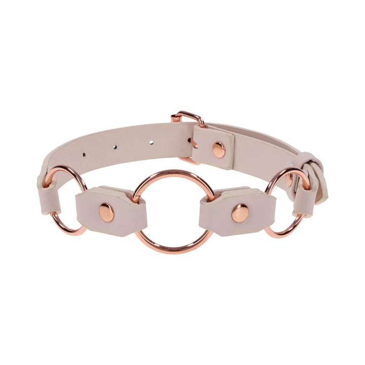 Smooth peach faux leather day collar with three rose gold rings across the front