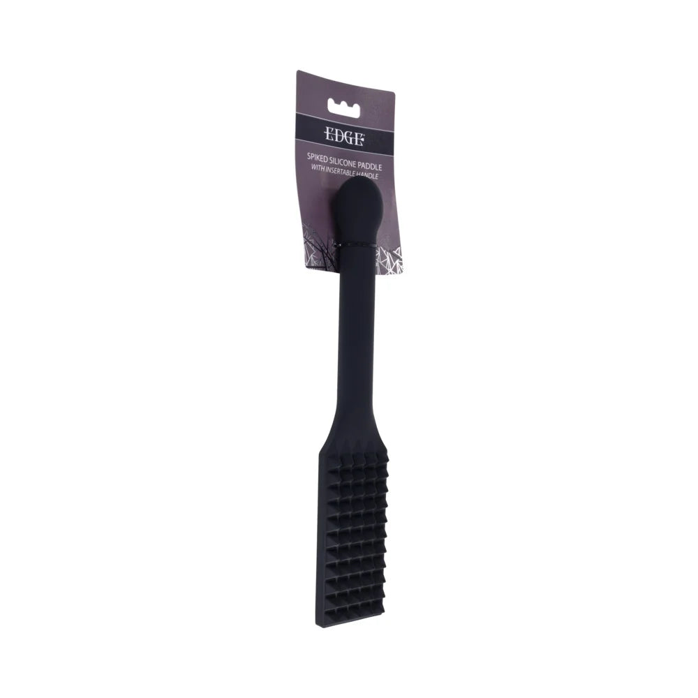 Black silicone paddle with rows of raised spikes across the head and a long reinforced handle