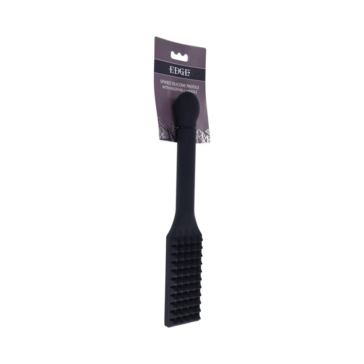 Black silicone paddle with rows of raised spikes across the head and a long reinforced handle