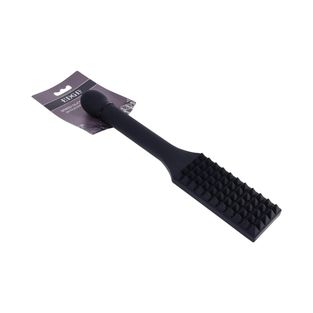 Black silicone paddle with rows of raised spikes across the head and a long reinforced handle