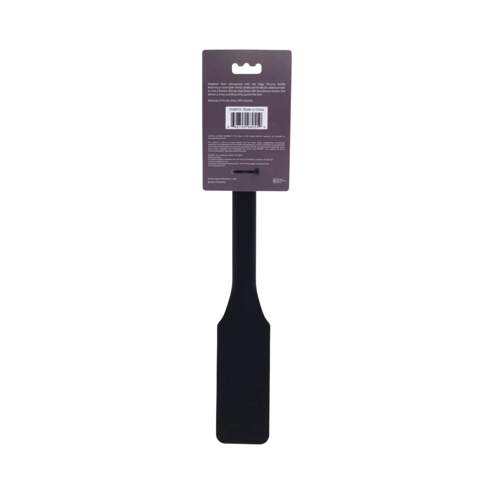 Black silicone paddle with a head covered in fine needle-like bristles and a long handle