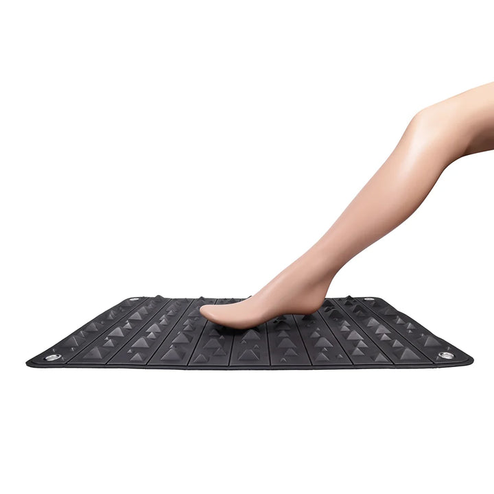 Black foam mat covered in pyramid spikes, shown rolled into its buckled faux leather holster
