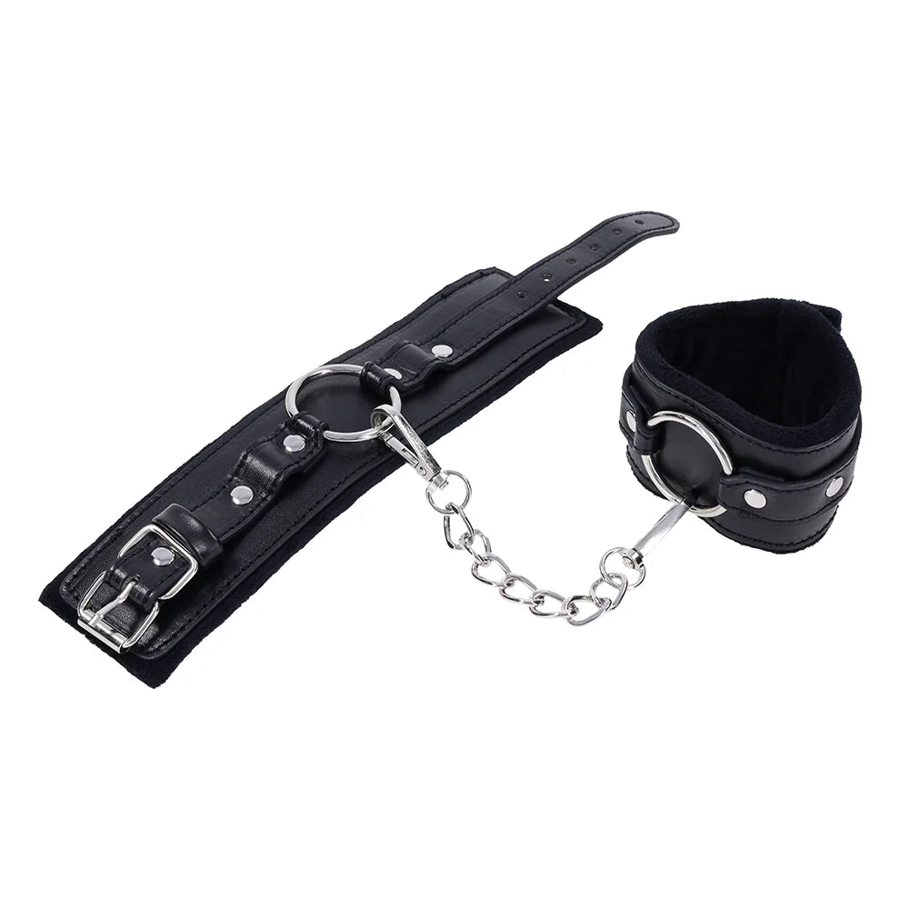 Black faux leather cuffs with silver O-ring connectors and a removable chain with gate clips