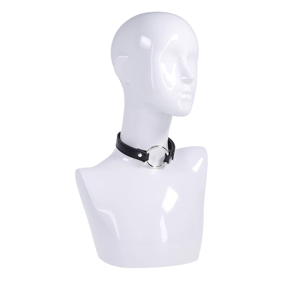 Black faux leather strap with a silver O-ring, worn as a bracelet, cross cuffs, or a day collar