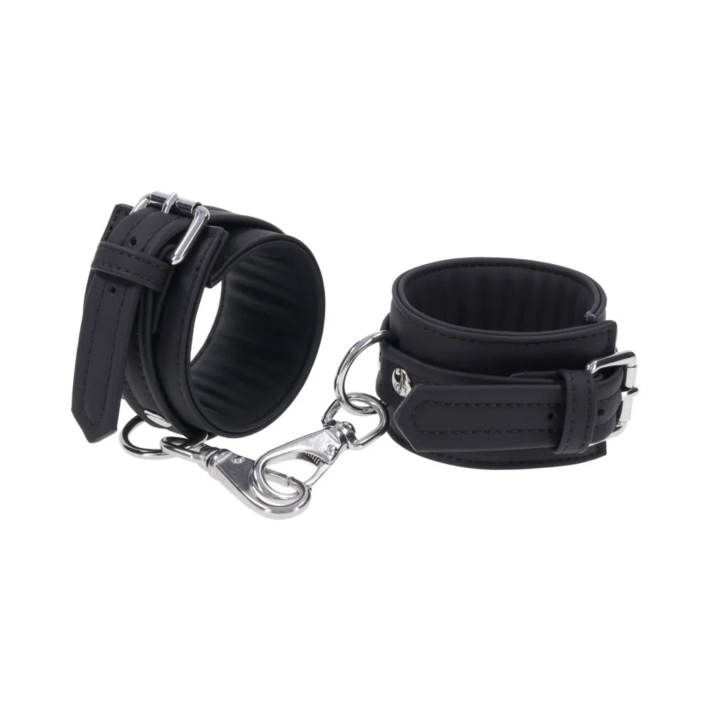 Midnight Muse: Black cashmere-touch silicone wrist cuffs with silver buckles and gate clips joined by a short chain