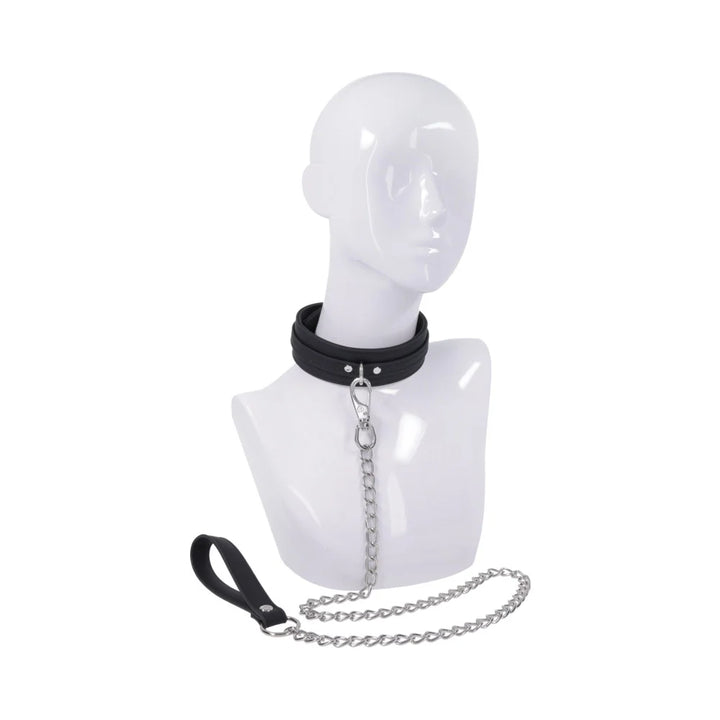 Black silicone collar with a silver buckle and a silver chain leash ending in a silicone wrist loop shown on a mannequin head