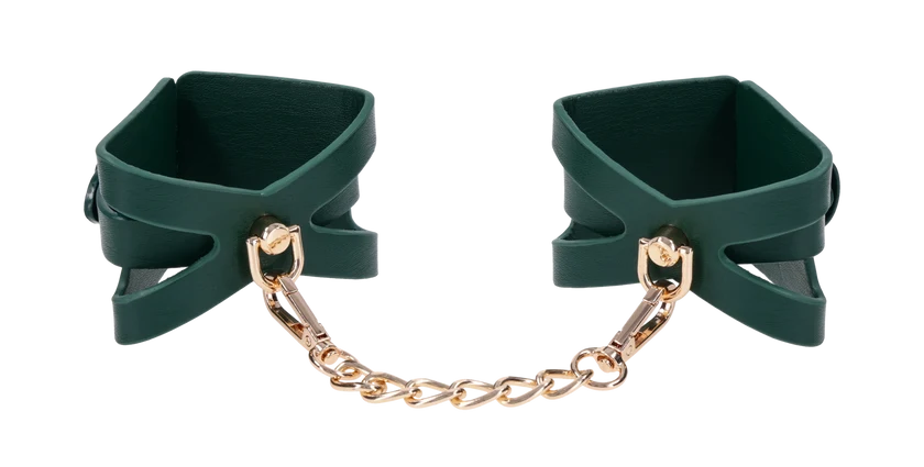 Emerald green faux leather wrist cuffs with cutout detailing and gold chain hardware