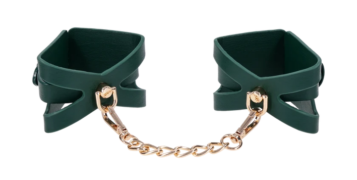 Emerald green faux leather wrist cuffs with cutout detailing and gold chain hardware